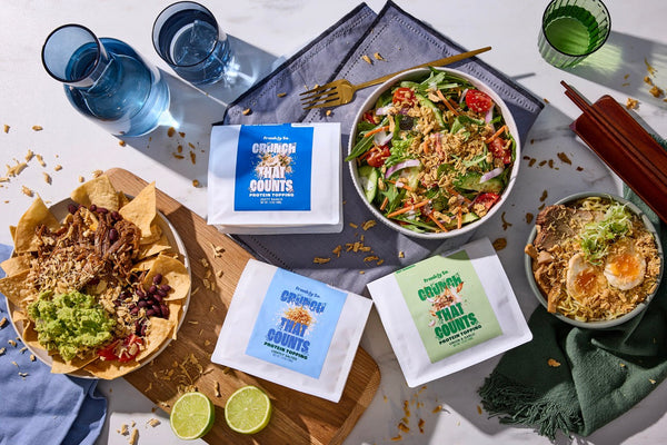Frankly So savory protein toppings in use — Zesty Ranch on a salad, Lightly Salted on loaded nachos, Onion & Garlic on a ramen bowl.
