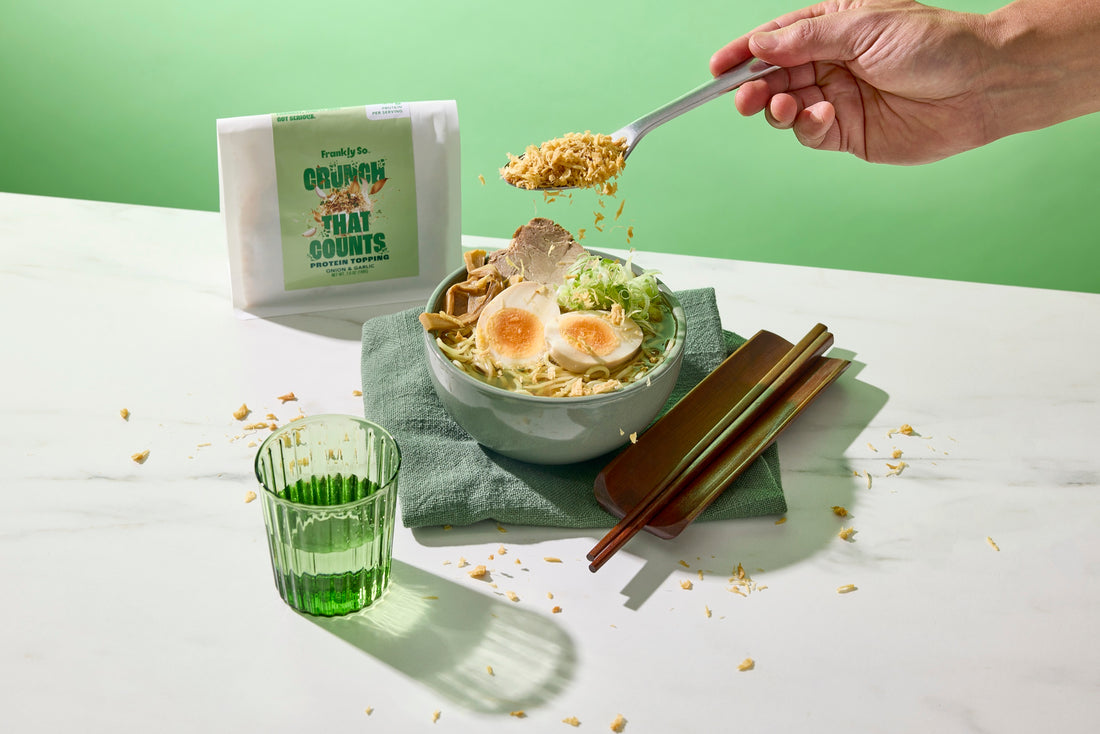 Onion and Garlic protein topping spooned over a ramen bowl with a soft egg