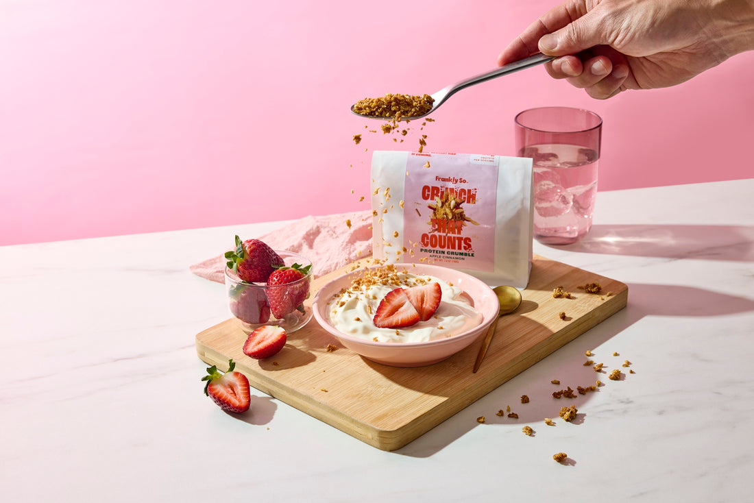 Apple Cinnamon protein crumble spooned over a bowl of strawberry yogurt