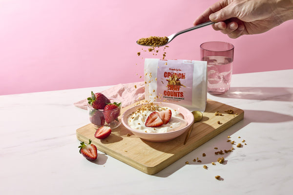 Apple Cinnamon protein crumble over a yogurt and strawberry bowl